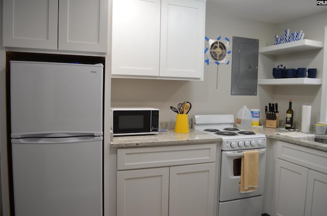 kitchen with white cabinetry, light stone counters, white appliances, and electric panel