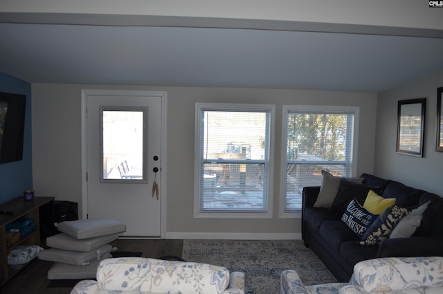 living room with vaulted ceiling and a healthy amount of sunlight