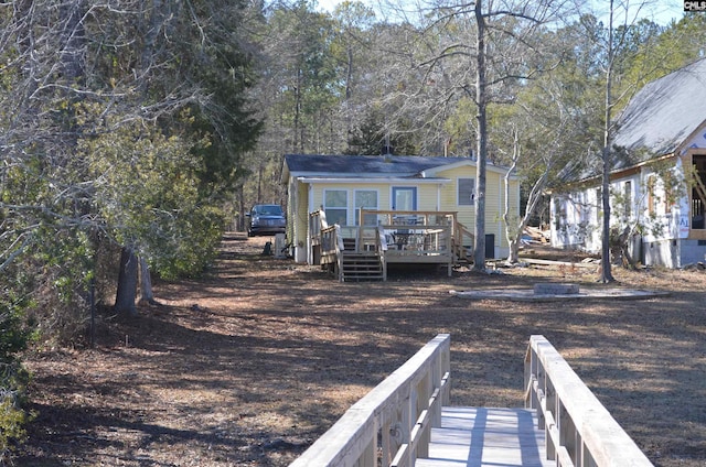 back of house featuring a deck