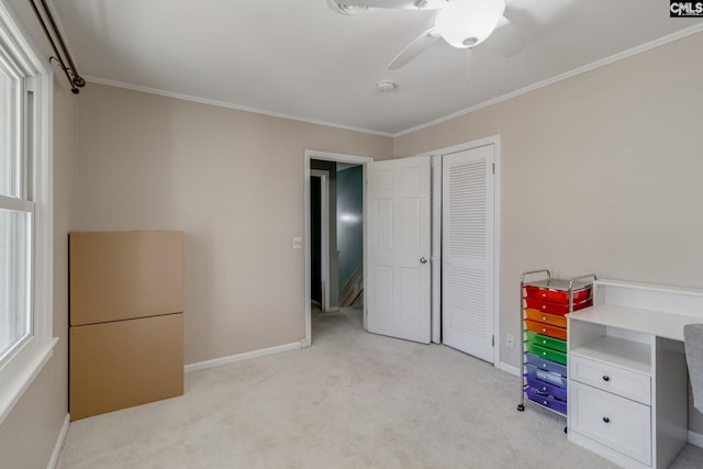 unfurnished office with ornamental molding, light colored carpet, and ceiling fan