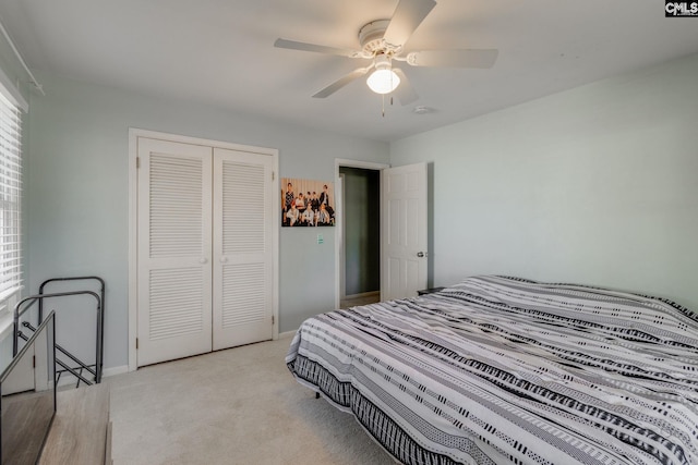 bedroom featuring ceiling fan, a closet, and light carpet