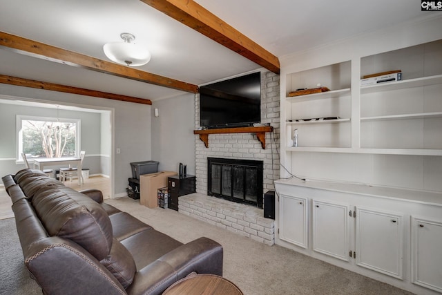 carpeted living room with a brick fireplace and beamed ceiling