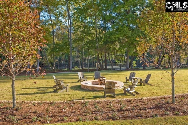 surrounding community with a yard and a fire pit