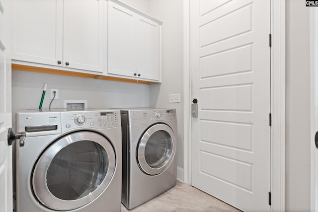 laundry room featuring cabinets and separate washer and dryer