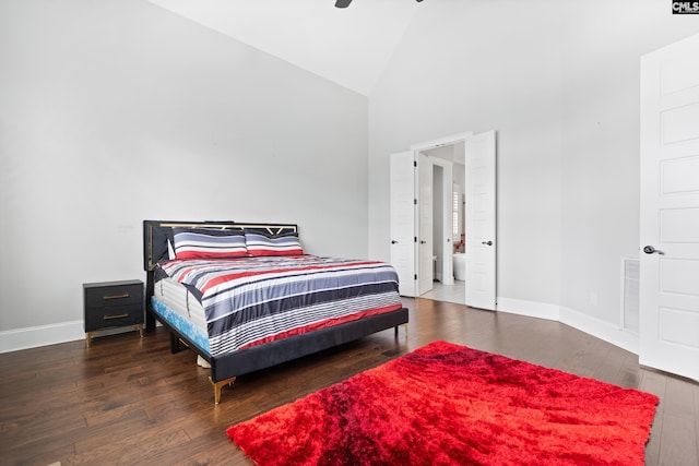 bedroom featuring ceiling fan, dark hardwood / wood-style flooring, and high vaulted ceiling