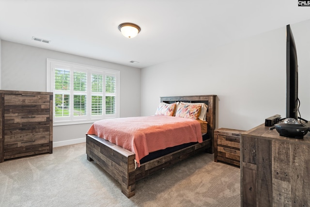 bedroom featuring light carpet