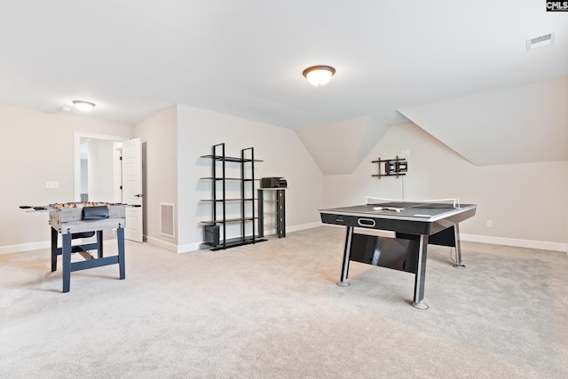 recreation room featuring vaulted ceiling and light carpet