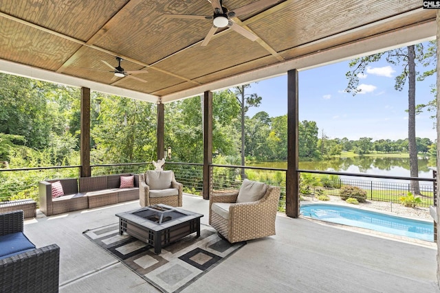 sunroom / solarium featuring a water view, wooden ceiling, and ceiling fan