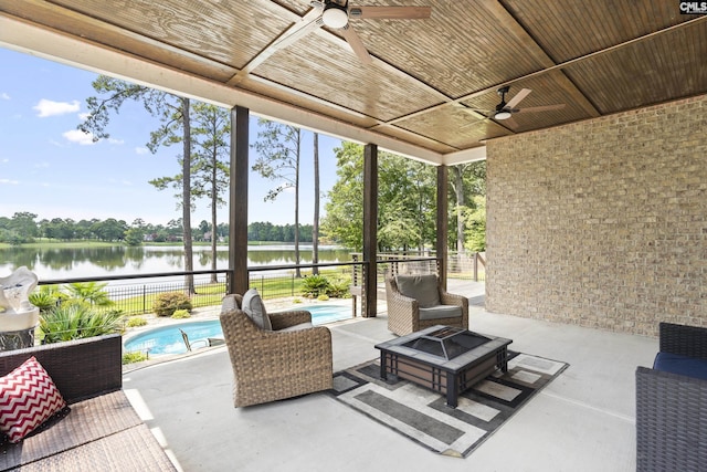 view of patio with a water view, a fenced in pool, and a fire pit