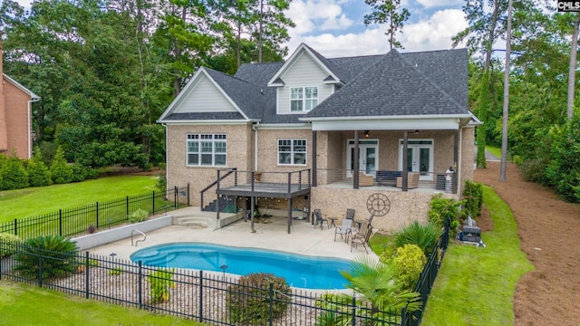 back of house with ceiling fan, a yard, a fenced in pool, and a patio