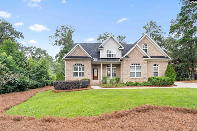 craftsman inspired home with a porch and a front yard