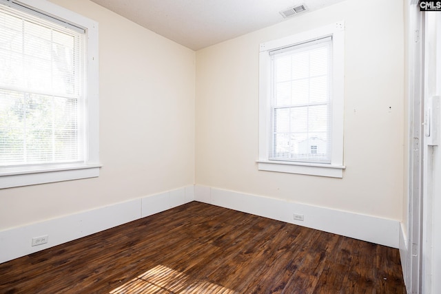 spare room with dark hardwood / wood-style flooring