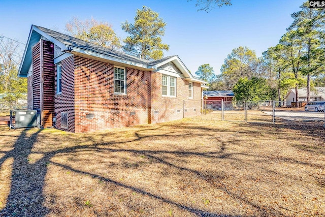 view of home's exterior featuring cooling unit and a yard