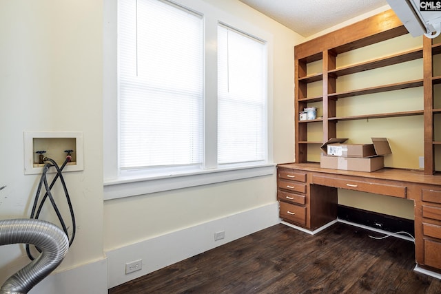 office with dark wood-type flooring and built in desk