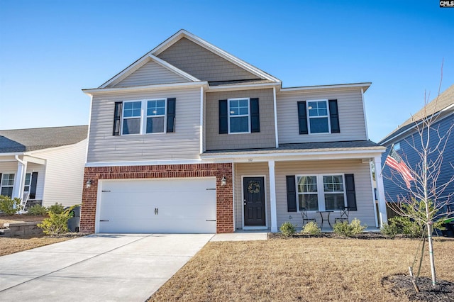 view of front facade with a garage, a front yard, and covered porch