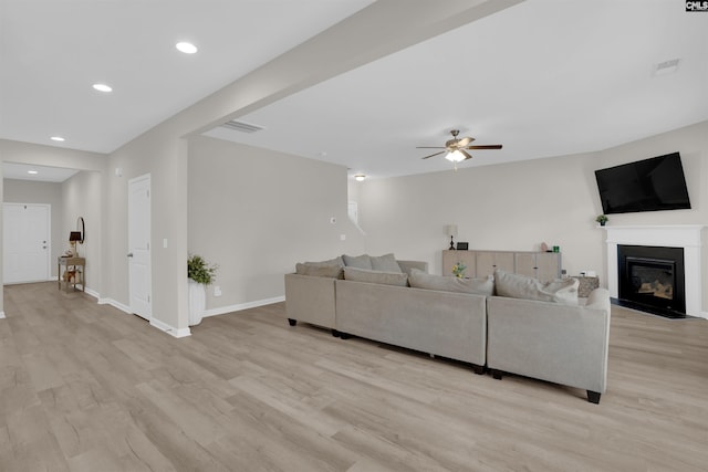 living room with ceiling fan and light hardwood / wood-style floors