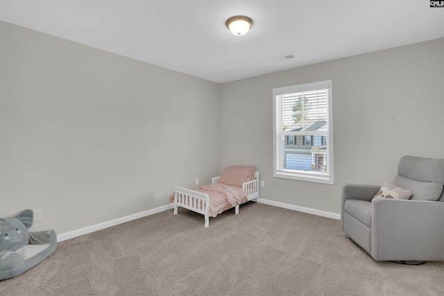 sitting room featuring light colored carpet