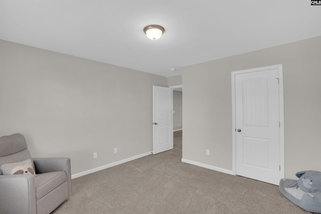 unfurnished room featuring light carpet