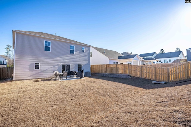 back of property with a yard, central AC unit, and a patio