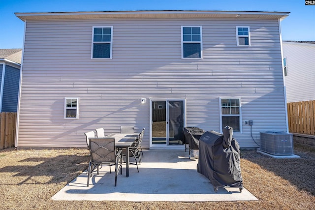 back of house with central AC unit and a patio