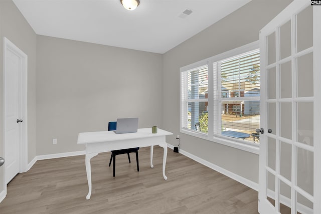 office with light hardwood / wood-style flooring