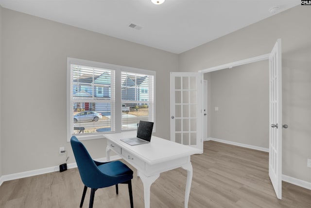 office area featuring french doors and light hardwood / wood-style floors