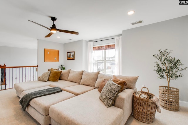 carpeted living room featuring ceiling fan