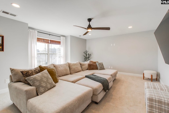 carpeted living room with ceiling fan