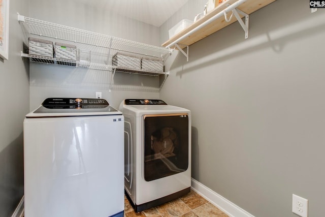 clothes washing area with washing machine and clothes dryer