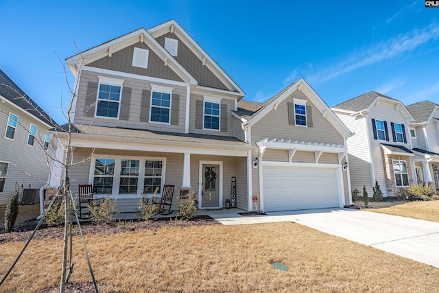 craftsman inspired home featuring cooling unit, a porch, and a front lawn