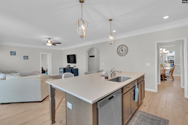 kitchen featuring sink, decorative light fixtures, an island with sink, and dishwasher