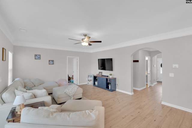 living room with ornamental molding, ceiling fan, and light hardwood / wood-style floors