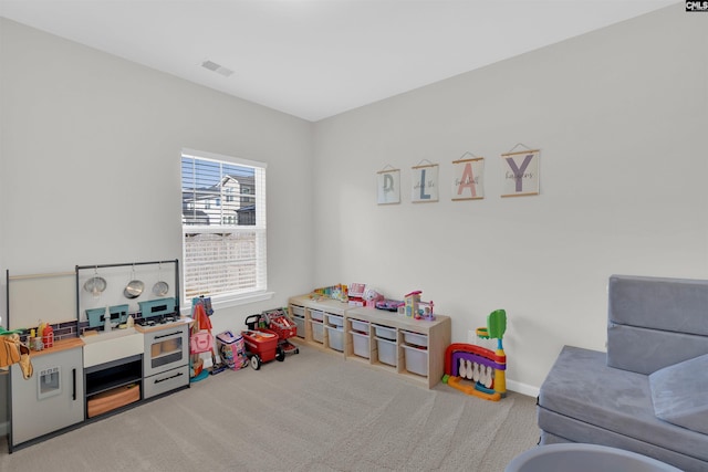 recreation room featuring light colored carpet