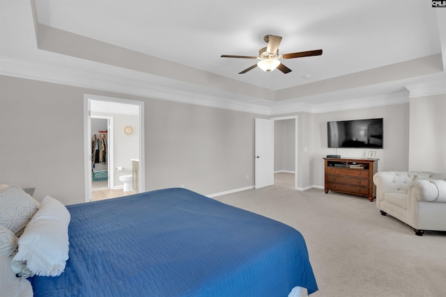 bedroom with crown molding, a tray ceiling, and light carpet