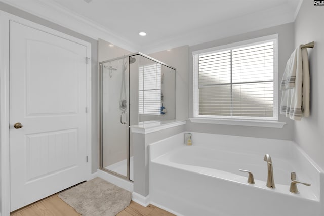 bathroom with crown molding and separate shower and tub