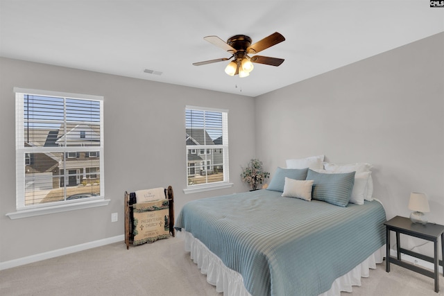 bedroom with ceiling fan and light colored carpet