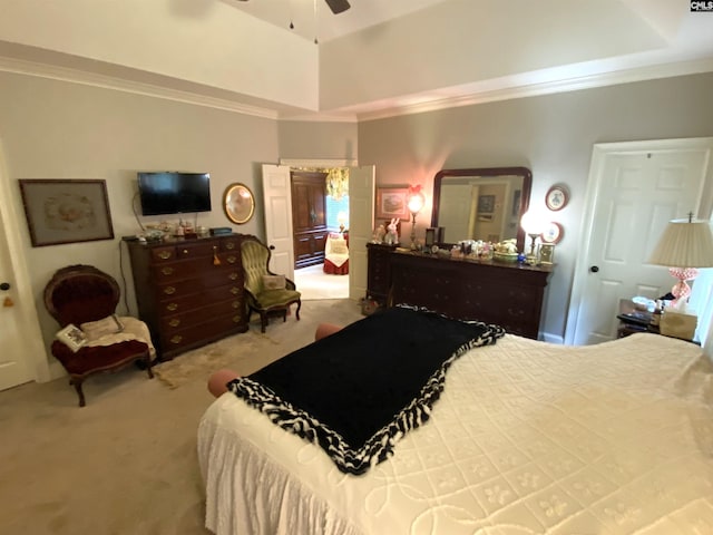 bedroom with carpet floors, ornamental molding, a raised ceiling, and ceiling fan