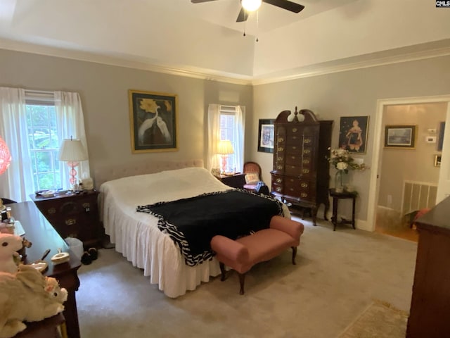 carpeted bedroom with ornamental molding and ceiling fan