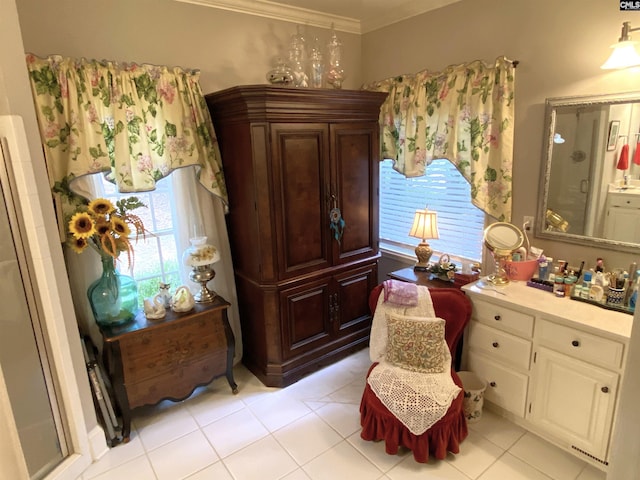 bathroom featuring a shower with door, vanity, ornamental molding, and tile patterned floors