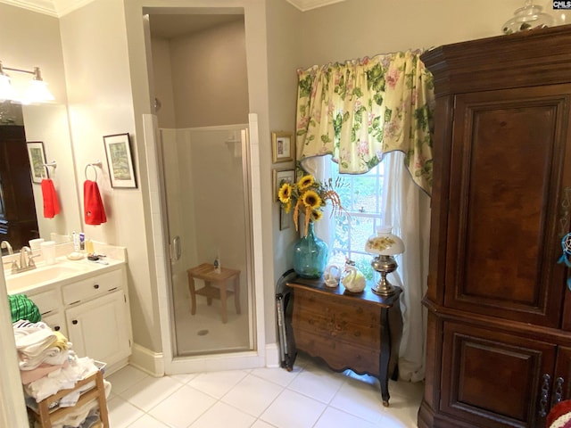 bathroom with crown molding, tile patterned floors, vanity, and a shower with shower door