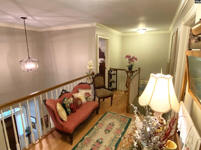 sitting room featuring crown molding and light wood-type flooring