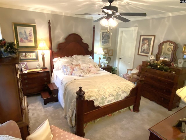 carpeted bedroom featuring crown molding and ceiling fan