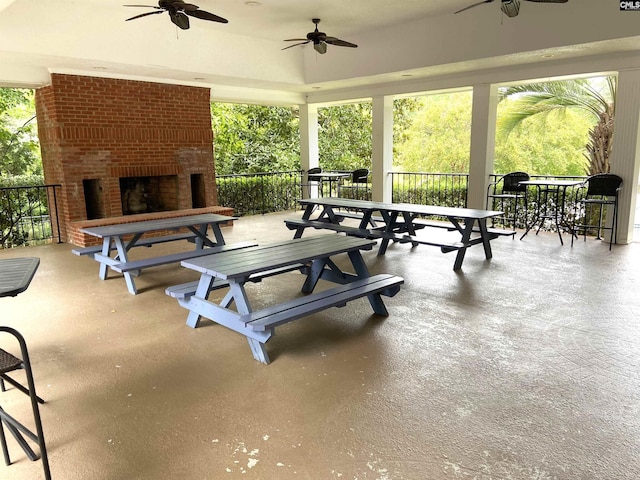 view of patio / terrace featuring an outdoor brick fireplace and ceiling fan