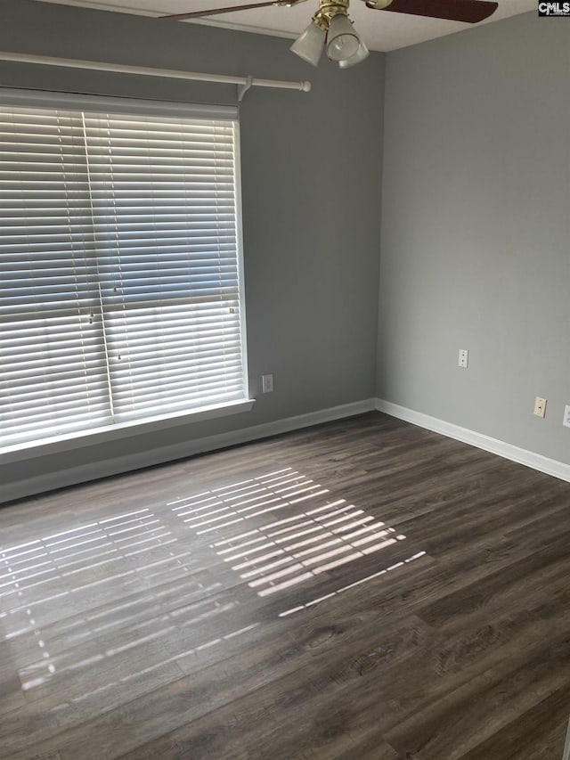 unfurnished room with dark wood-type flooring and ceiling fan