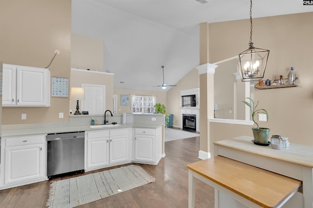 kitchen featuring sink, decorative light fixtures, white cabinets, and dishwasher