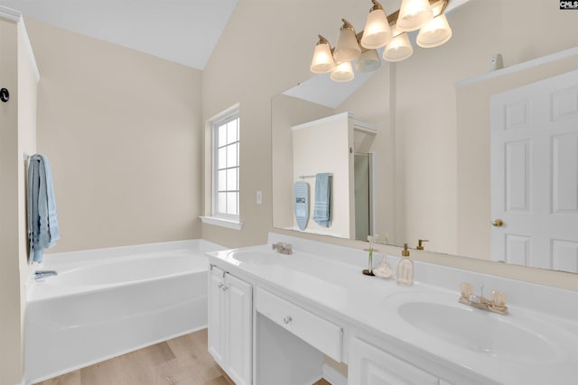 bathroom with shower with separate bathtub, wood-type flooring, lofted ceiling, a chandelier, and vanity