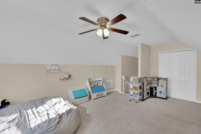 interior space with carpet floors, ceiling fan, vaulted ceiling, and a textured ceiling