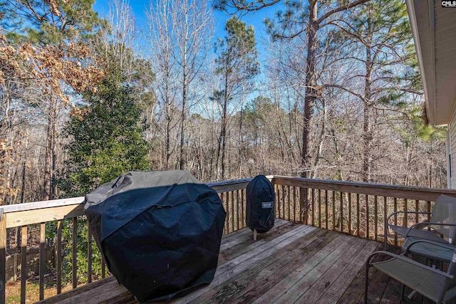 wooden deck featuring a grill