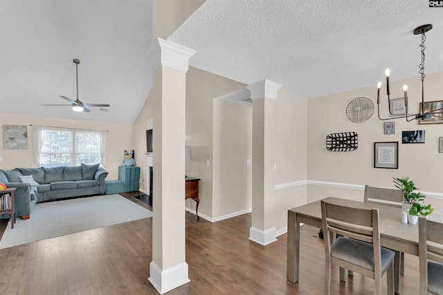 dining area with ceiling fan, dark hardwood / wood-style floors, decorative columns, and a textured ceiling