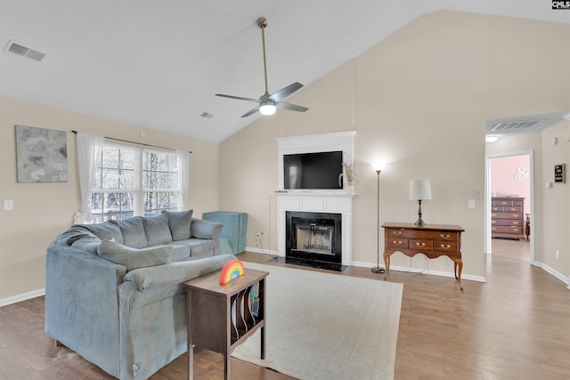 living room featuring wood-type flooring, high vaulted ceiling, and ceiling fan